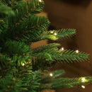 Close-up of a Christmas tree with string lights on a blurred background